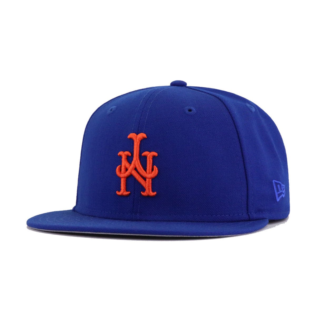 A fitted baseball cap with the New York Mets logo in orange and grey on a light royal blue background.